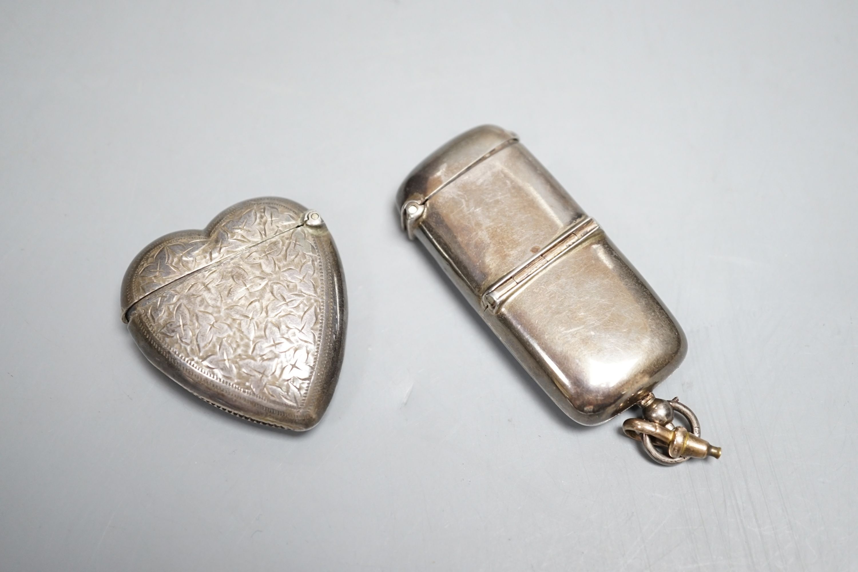 An Edwardian silver combination sovereign and vesta case, Robert Pringle & Sons, Birmingham, 1907, 62mm, with engraved inscription and a later Victorian silver heart shaped vesta case, Birmingham, 1897.